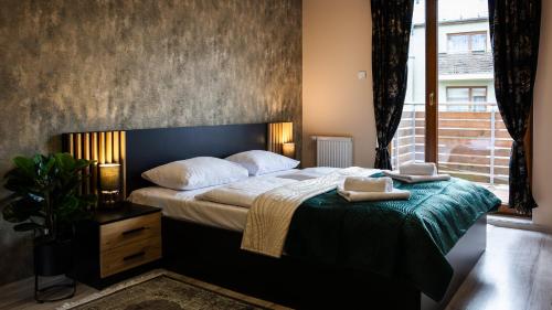 a bedroom with a bed with a laptop on it at Wczasowa, Sun & Snow in Ustka