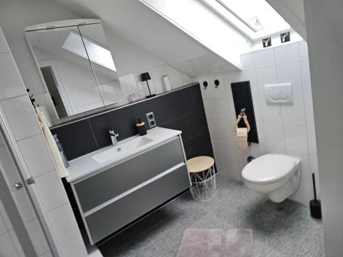 a bathroom with a sink and a toilet at Wohlfuehloase24 in Gütersloh