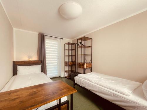 Postel nebo postele na pokoji v ubytování Bungalows am Buchenkampweg