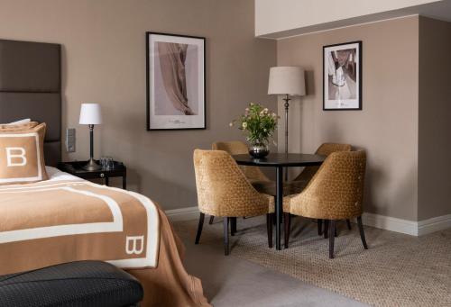 a hotel room with a bed and a table and chairs at Hotel Haven in Helsinki