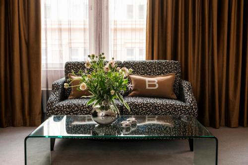 a living room with a couch and a glass coffee table at Hotel Haven in Helsinki