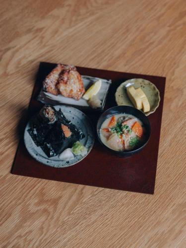 a plate with different types of food on a table at Hotel K5 in Tokyo