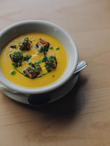a bowl of soup with broccoli in it on a table at Hotel K5 in Tokyo