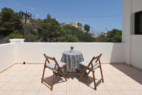 a table and two chairs sitting on a patio at Maridim studios in Ermoupoli