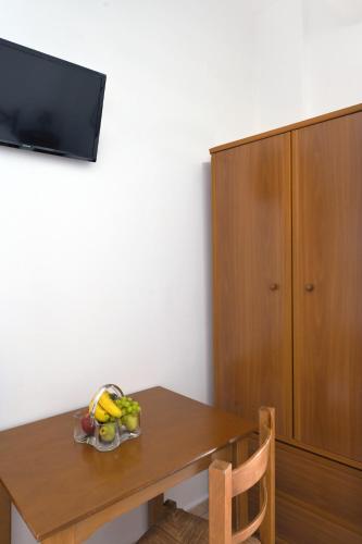 a room with a wooden table and a cabinet at Maridim studios in Ermoupoli