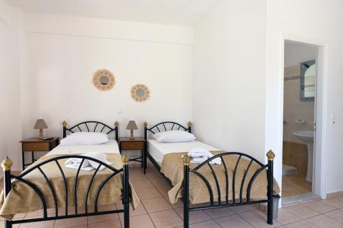 two beds sitting next to each other in a room at Maridim studios in Ermoupoli