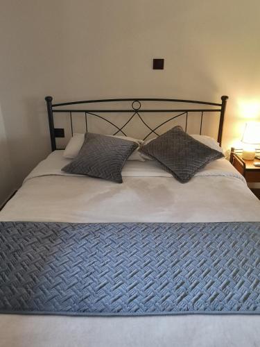 a bed with two pillows on top of it at Πολύμνια in Agia Anna