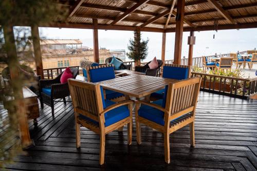 a wooden table and chairs on a deck at Sukoon Houseboat Dal Lake in Durgjan