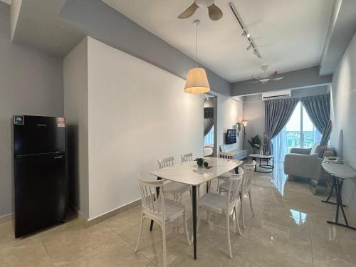 a kitchen and dining room with a table and chairs at ICC Ipoh Town Premium Suites By IWH Suites in Ipoh