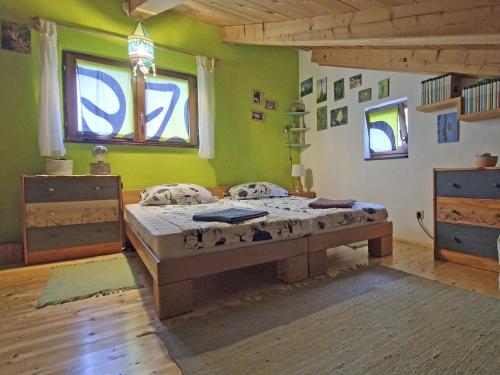 a bedroom with a bed in a room with green walls at Nives Garden house in Nerezine