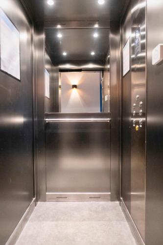 a elevator in a building with a mirror at Mandera's Boutique Suites & Dorms in Valletta