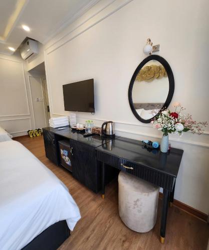 a bedroom with a desk with a mirror and a bed at BREAKING DAWN- TAEYANG Hotel Phú Quốc in Phu Quoc