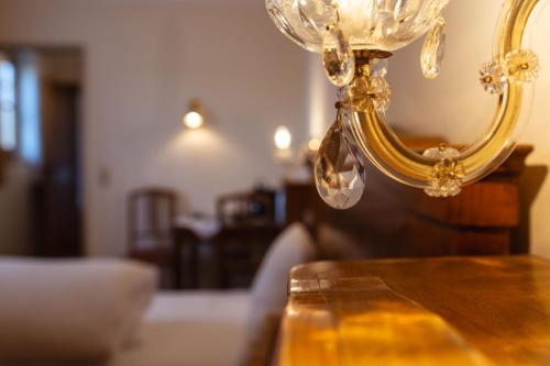 a chandelier sitting on top of a wooden table at Gästehaus Goldener Stern in Lienz