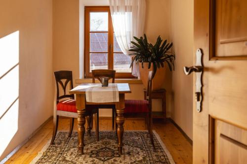 a table and chairs in a room with a window at Gästehaus Goldener Stern in Lienz