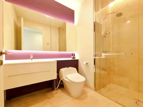 a bathroom with a toilet and a sink and a shower at Tropicana The Residence KLCC in Kuala Lumpur