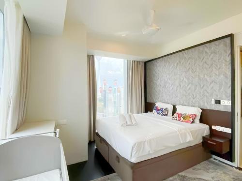 a bedroom with a large bed and a large window at Tropicana The Residence KLCC in Kuala Lumpur