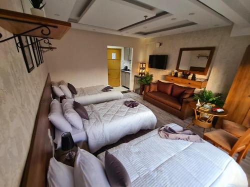 a bedroom with two beds and a living room at tourist hotel cairo downtown in Cairo