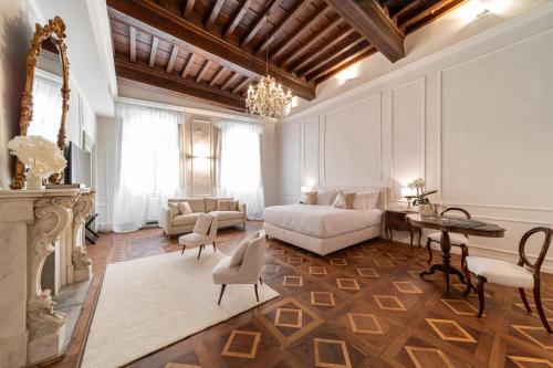 a bedroom with a bed and a table and chairs at La Casa di Liszt - Luxury Suites in Florence