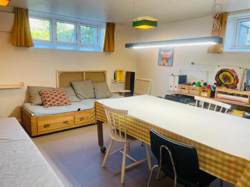 a bedroom with a large bed and a desk at Charmerende kælderlejlighed i villa in Bronshoj