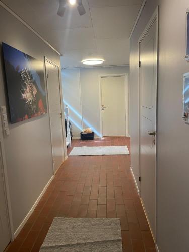 a hallway with a tile floor and a hallway with a door at Nice and comfortable apartment in Asker
