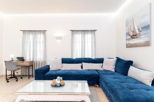 a blue couch in a living room with a table at Villa Irene Royale - Pool - Sea View - Free Cruise in Tigaki