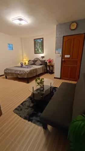a bedroom with a bed and a living room at Kata Lina guesthouse in Kata Beach