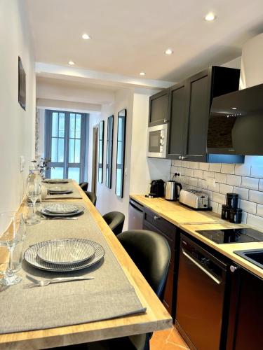 une cuisine avec une table avec des assiettes dessus dans l'établissement The62, à Carcassonne