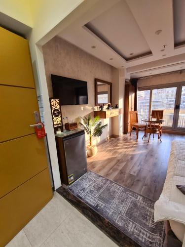 a living room with a yellow door and a kitchen at tourist hotel cairo downtown in Cairo