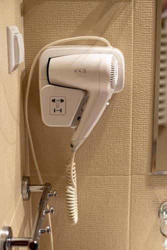 a hairdryer on a wall in a bathroom at Dom rekolekcyjny Vincentinum in Krzeszowice