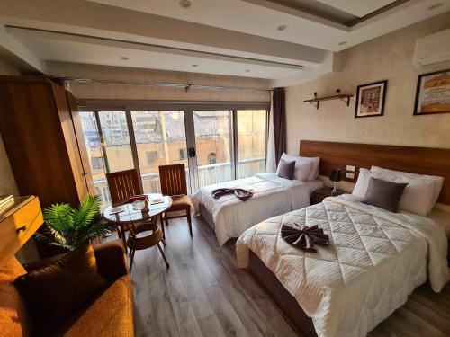 a hotel room with two beds and a table at tourist hotel cairo downtown in Cairo