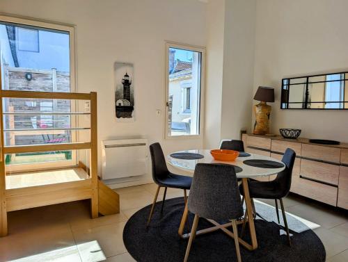 une salle à manger avec une table et des chaises dans l'établissement Élégante Maison de ville, à Pornic
