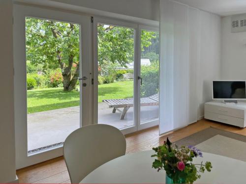 a living room with french doors leading to a patio at Ferienwohnung Peterberg in Kirchzarten