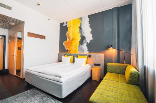 a bedroom with a white bed and a yellow wall at Comfort Hotel Sello in Espoo
