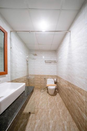 a bathroom with a sink and a toilet at Quoc Cuong Center Da Nang Hotel by Haviland in Da Nang
