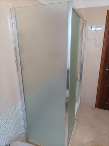 a glass shower door in a bathroom with a toilet at La Sosta in Lunigiana in Monti di Licciana Nardi