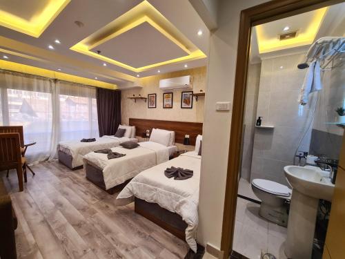 a hotel room with two beds and a sink at tourist hotel cairo downtown in Cairo