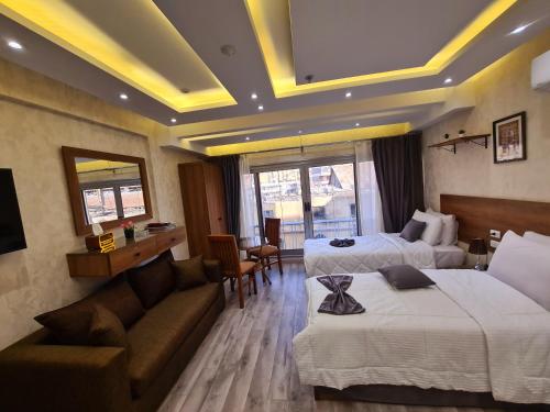a hotel room with two beds and a couch at tourist hotel cairo downtown in Cairo