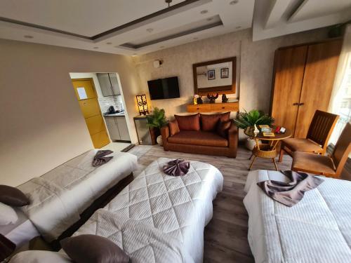 a hotel room with two beds and a couch at tourist hotel cairo downtown in Cairo