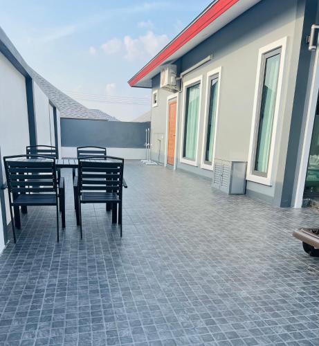 a patio with chairs and a table on a house at Vina Villa At Krabi in Ao Nang 