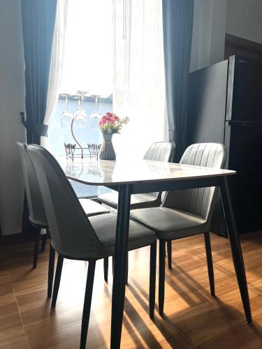 a dining room table and chairs with a window at Vina Villa At Krabi in Ao Nang 