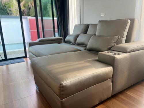 a brown leather couch in a living room at Vina Villa At Krabi in Ao Nang 