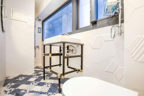 a bathroom with a sink and a toilet at Village Hostel in Xiaoliuqiu