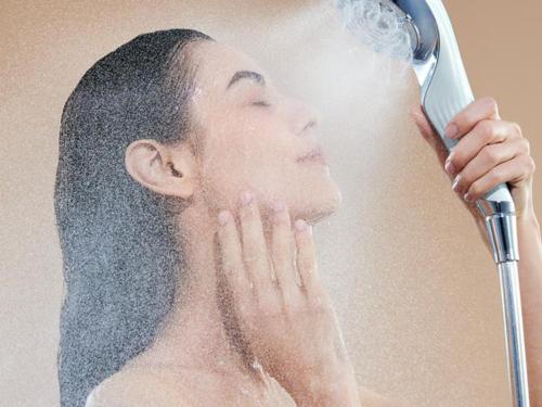 a man getting his hair brushed with a blow dryer at Henn na Hotel Tokyo Akasaka in Tokyo