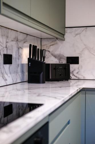 a kitchen counter with a knife block on it at Modern Comfort in Old Aberdeen in Aberdeen