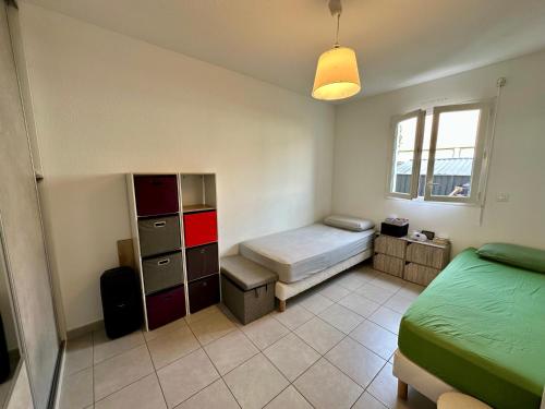 une petite chambre avec un lit et une fenêtre dans l'établissement Appartement Cardellina Jardin & Ville, à Calvi
