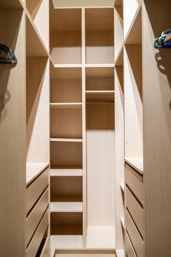 a walk in closet with white shelves at Villa Irene Royale - Pool - Sea View - Free Cruise in Tigaki