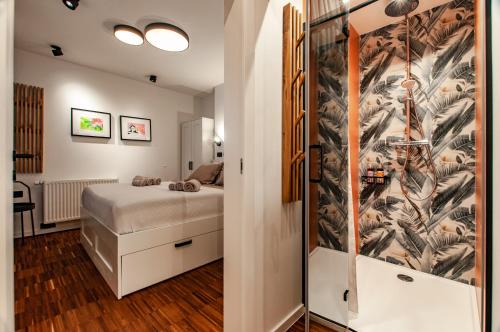 a bedroom with a bed and a wall mural at SIX IN THE CITY Apartment, LJUBLJANA in Ljubljana