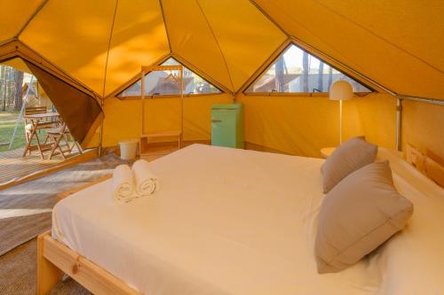 a bedroom in a tent with a bed at Camping Pla de la Torre in Sant Antoni de Calonge