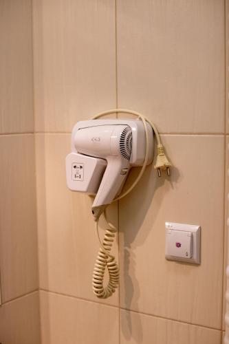 a hairdryer hanging on a wall in a bathroom at Dom rekolekcyjny Vincentinum in Krzeszowice