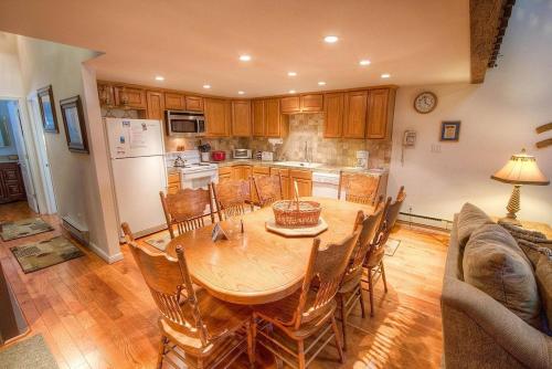 a kitchen with a wooden table and chairs and a kitchen with a refrigerator at Eagle's Lake Retreat condo in Incline Village
